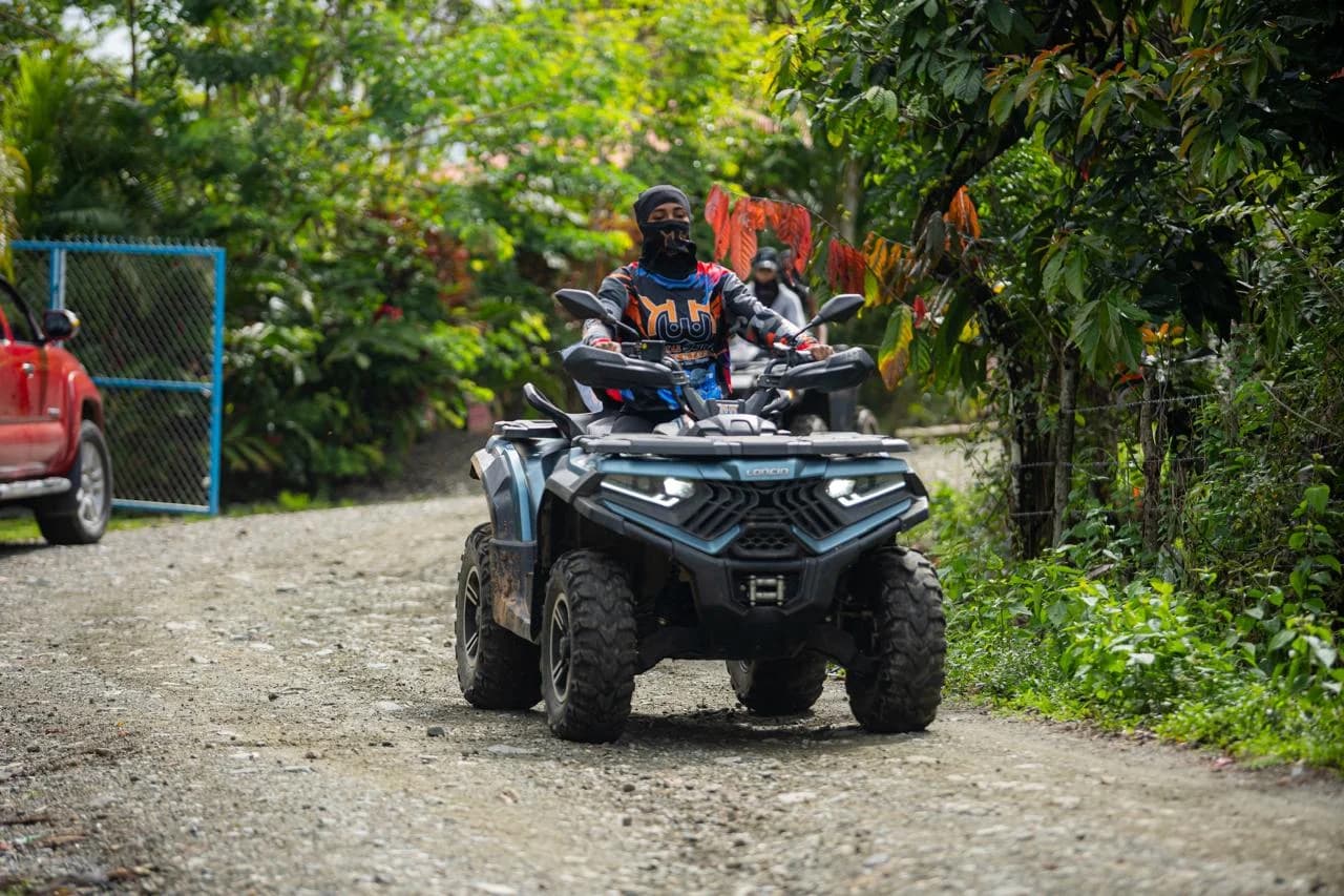 Rider on an ATV riding a forest gravel trail on the ATV tour from Santo Domingo