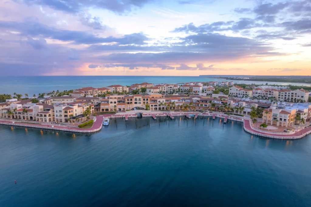 Aerial view of Cap Cana Marina in the Dominican Republic at sunset, showcasing luxury resorts, waterfront villas, and world-class marina.