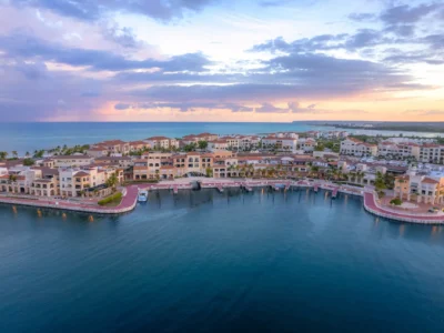 Aerial view of Cap Cana Marina in the Dominican Republic at sunset, showcasing luxury resorts, waterfront villas, and world-class marina.