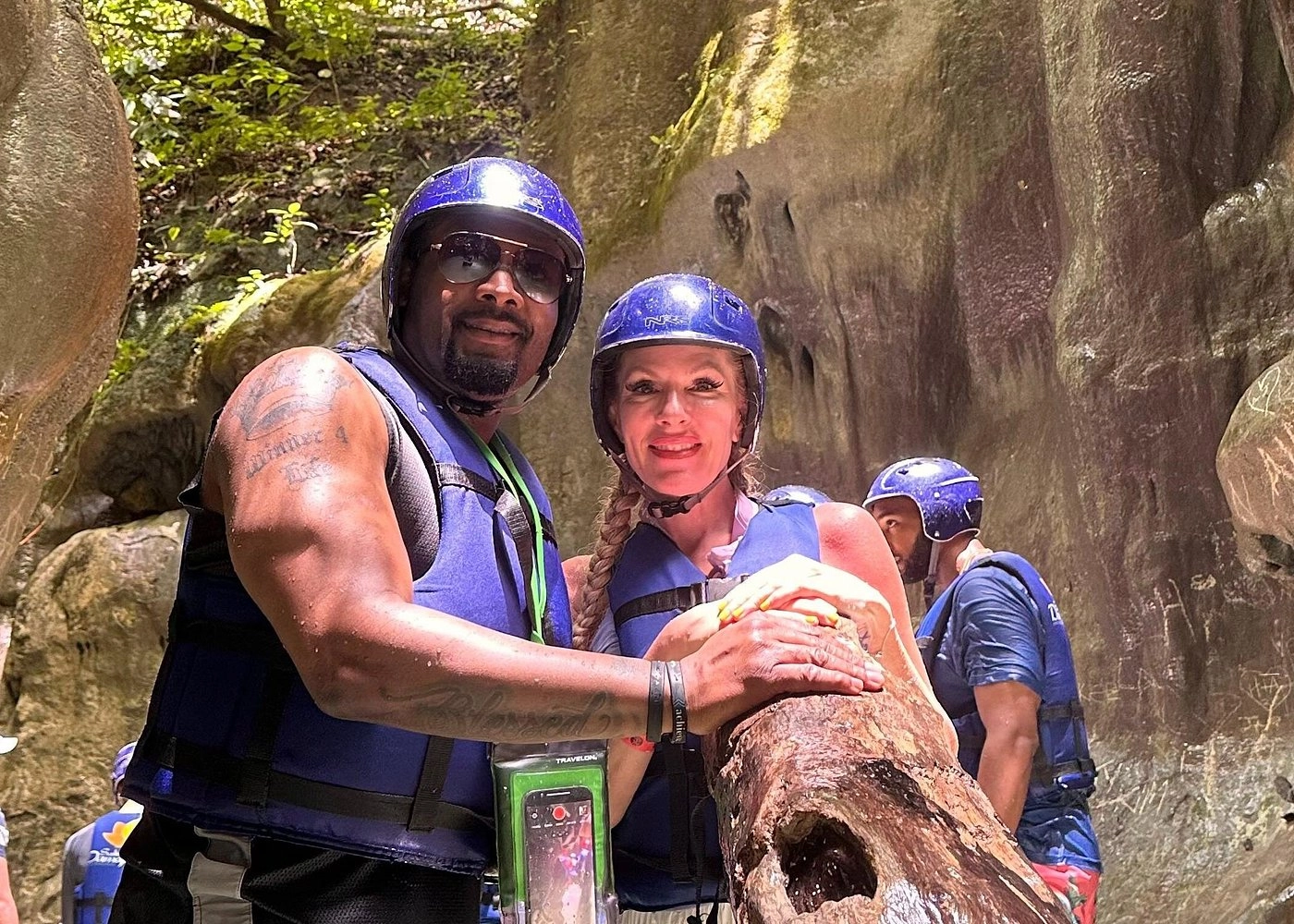 Couple in helmets and lifejackets smiling at the 27 Waterfalls of Damajagua.