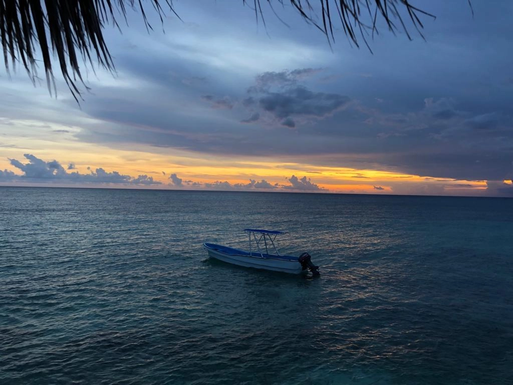Boat on turquoise waters at sunset in Cabo Rojo Dominican Republic