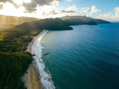 Aerial view of El Valle Beach surrounded by lush mountains in Samaná