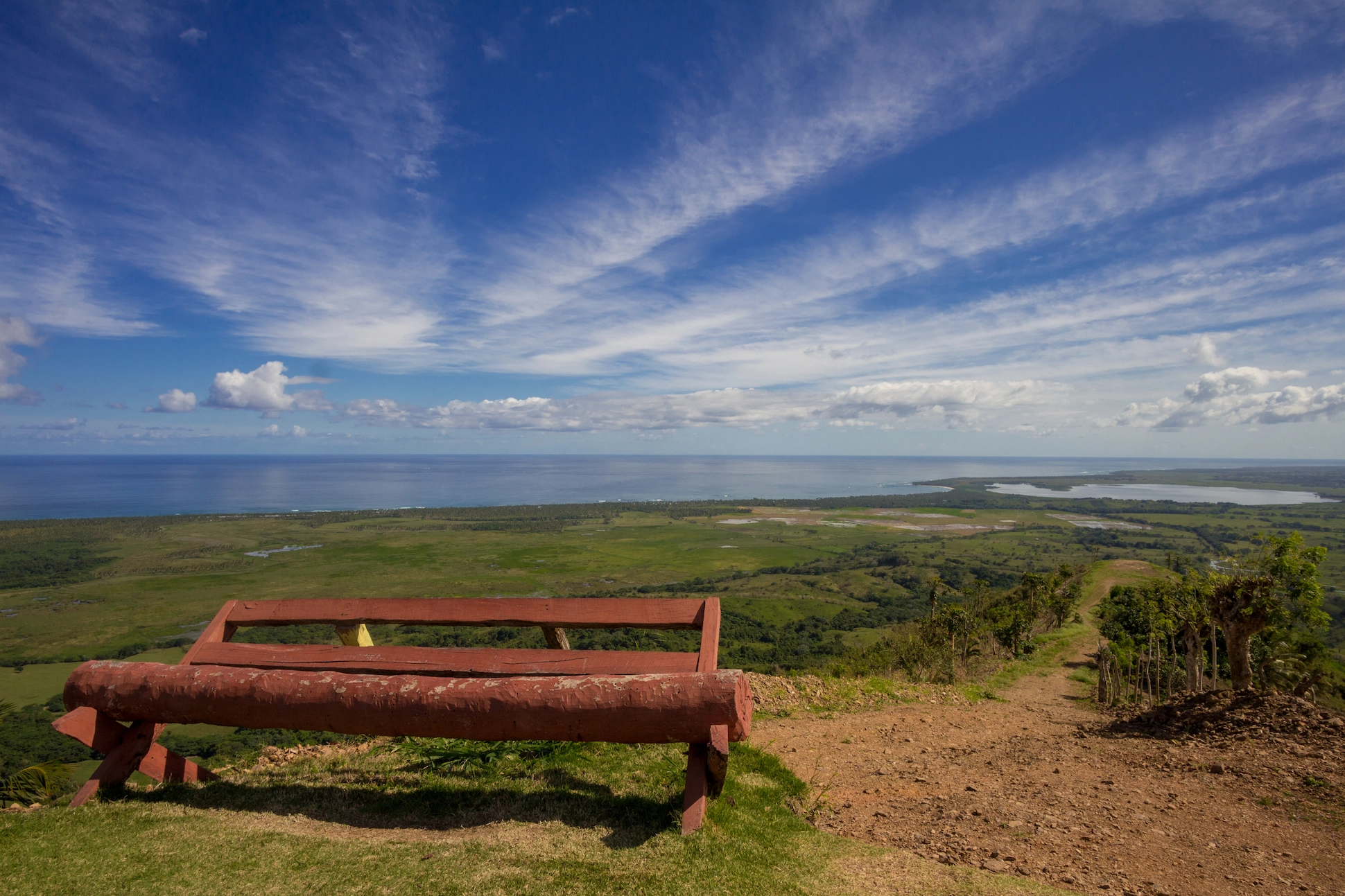 Wooden bench at Montaña Redonda with panoramic views of coastline and lagoons in the Dominican Republic.