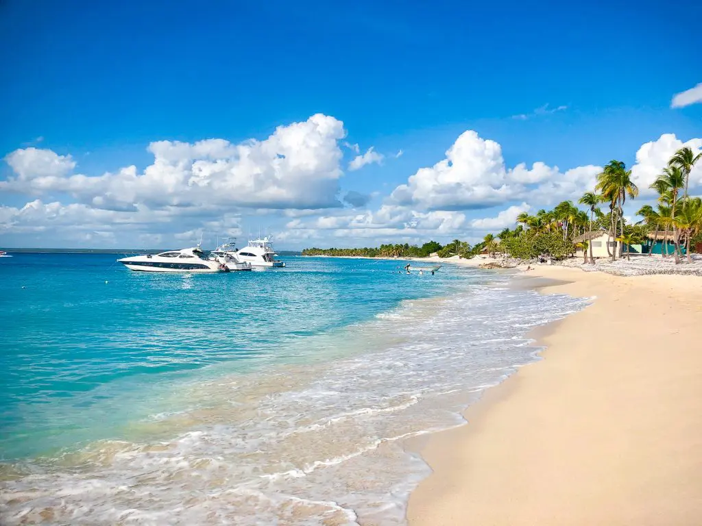 White sandy beach with boats anchored at Catalina Island, Dominican Republic