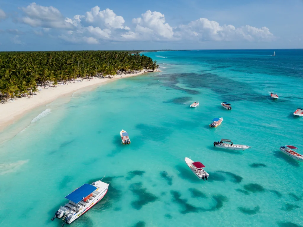 Tourists sailing on a catamaran in Isla Saona with blue sky and ocean