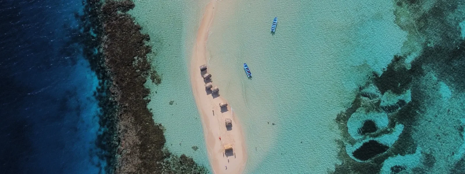 Aerial drone view of Cayo Arena Paradise Island in the Dominican Republic, surrounded by coral reefs and turquoise waters