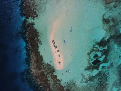 Aerial drone view of Cayo Arena Paradise Island in the Dominican Republic, surrounded by coral reefs and turquoise waters