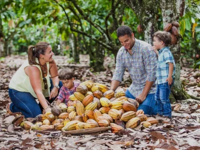 Family with children exploring cocoa pods at El Sendero del Cacao plantation during the Chocolate Tour Santo Domingo