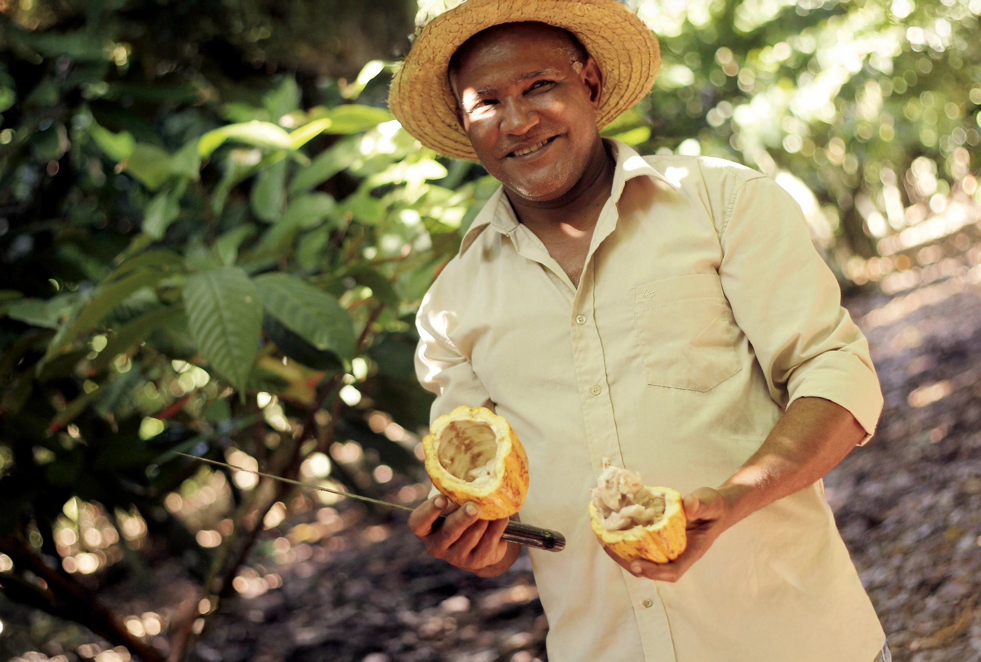 Cocoa farmer in San Francisco de Macorís holding an open cacao pod during the Chocolate Tour Santo Domingo