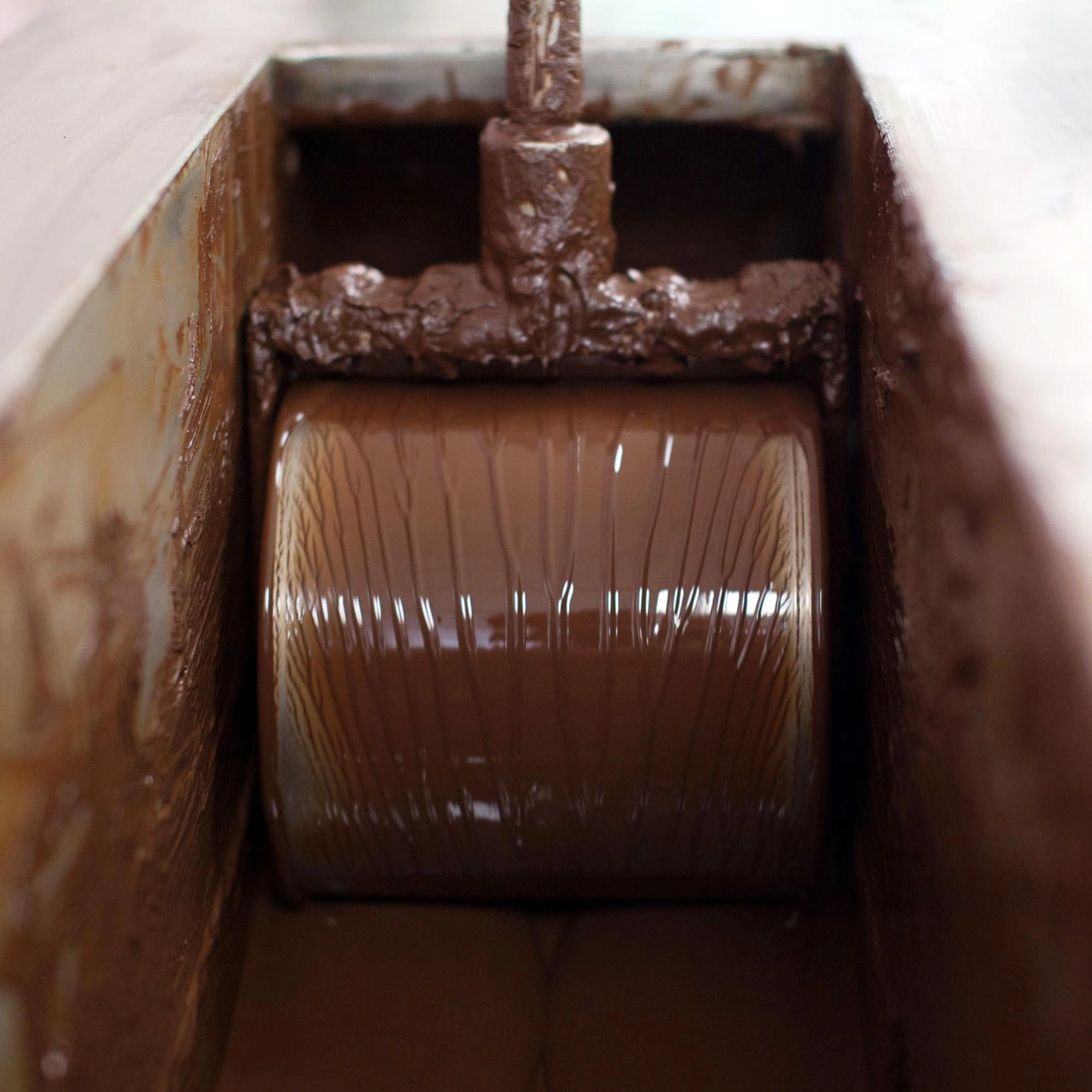 Close-up of a chocolate conching machine processing cocoa at El Sendero del Cacao during the Chocolate Tour Santo Domingo