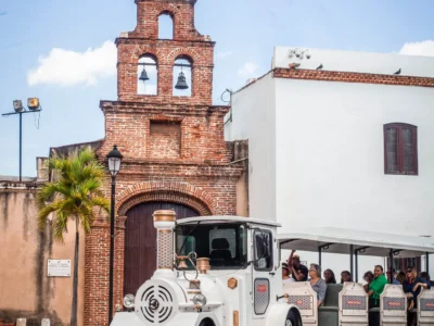 Chu Chu Colonial Train passing by a historic church in Santo Domingo’s Colonial Zone.