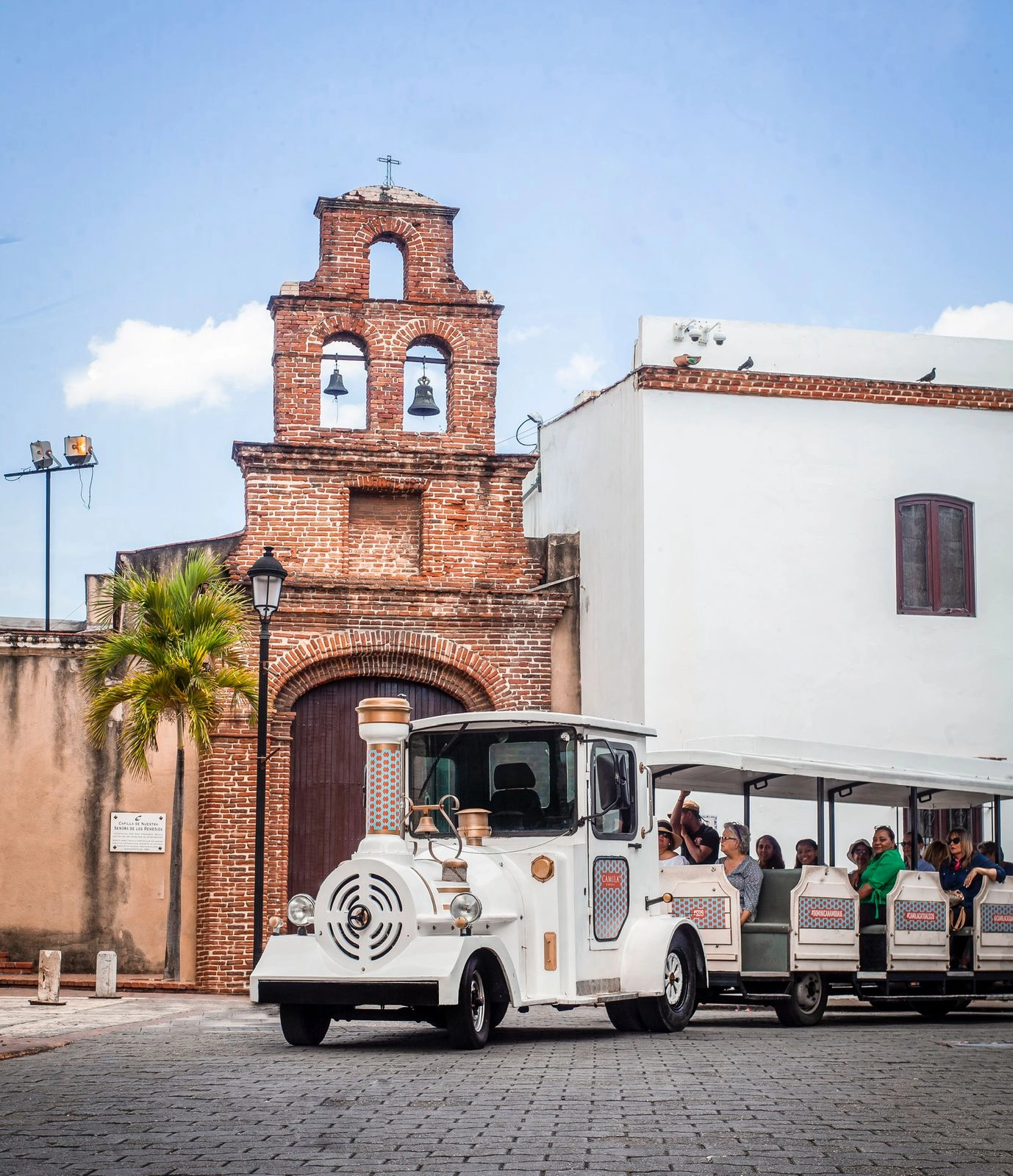 Chu Chu Colonial Train passing by a historic church in Santo Domingo’s Colonial Zone.