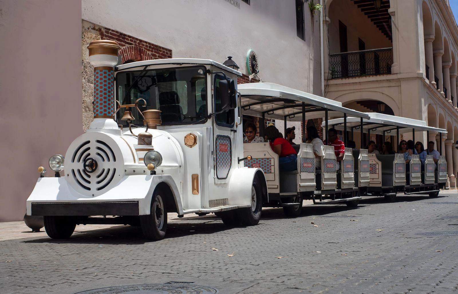 Chu Chu Colonial tourist train driving through the streets of Santo Domingo’s Colonial Zone with visitors on board.