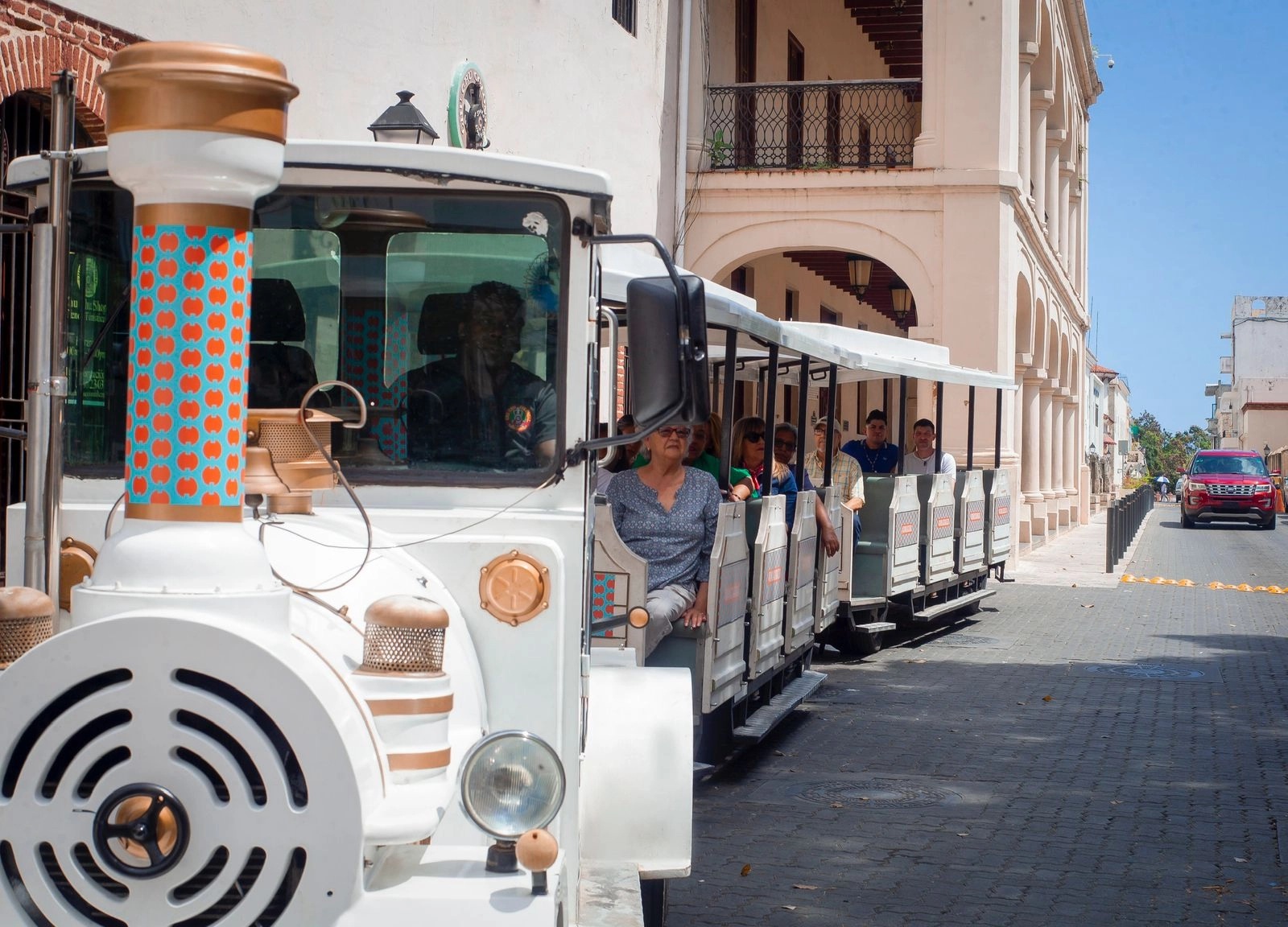 Chu Chu Colonial Train with passengers riding through the streets of Santo Domingo’s Colonial Zone.