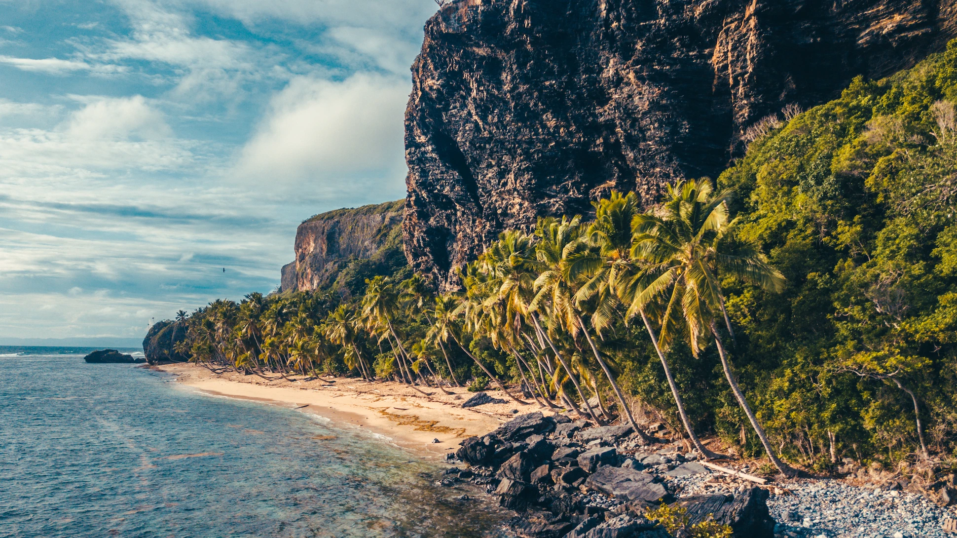 Aerial view of Playa Frontón’s coastline with coral reef and cliffs in Samaná.