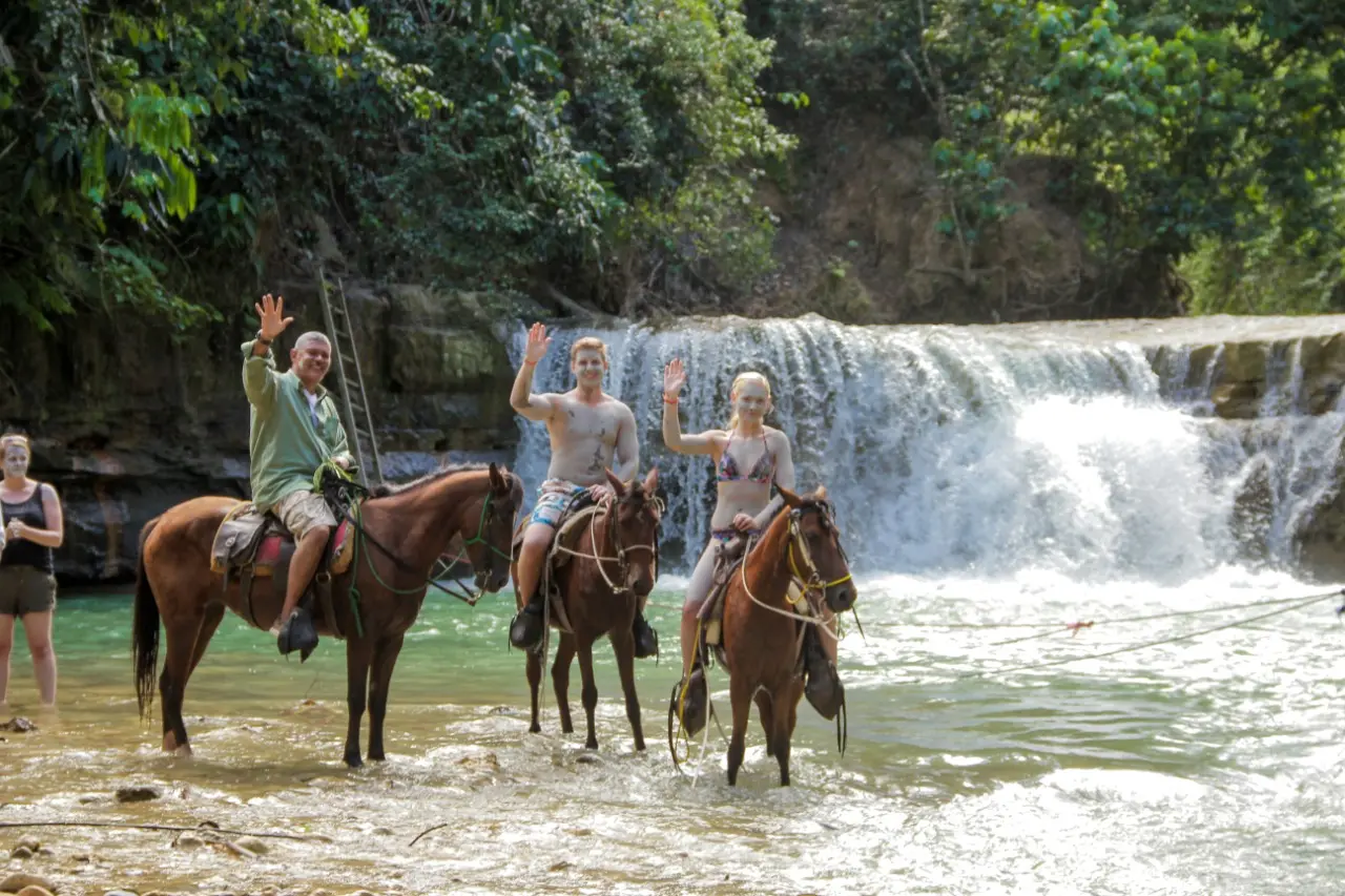 Tourists horseback riding at Salto de Yanigua waterfall in Hato Mayor, Dominican Republic during the Amber Route tour