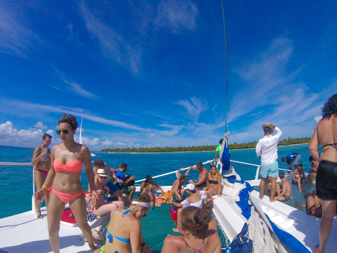 Travelers relaxing on a catamaran deck en route to Isla Saona.