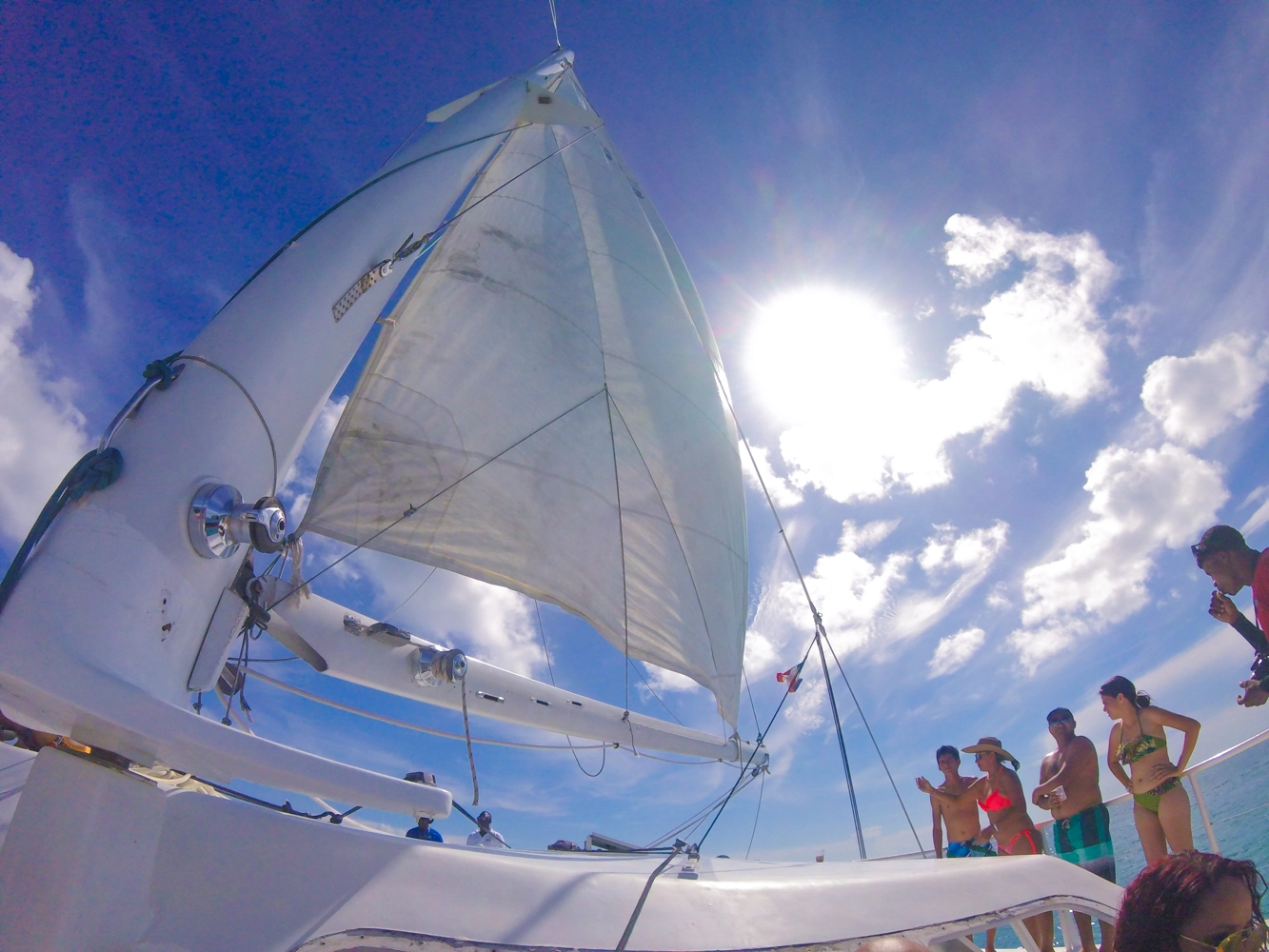 Catamaran sailing toward Isla Saona with passengers enjoying the breeze.