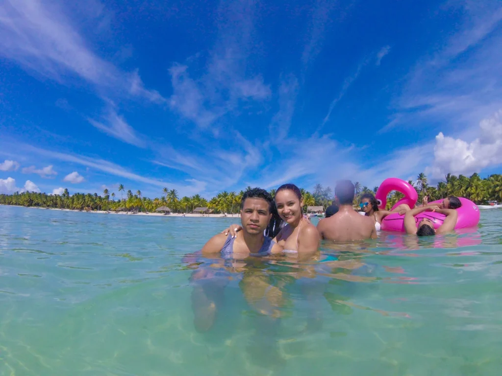 People swimming and relaxing in the natural pool before reaching Isla Saona