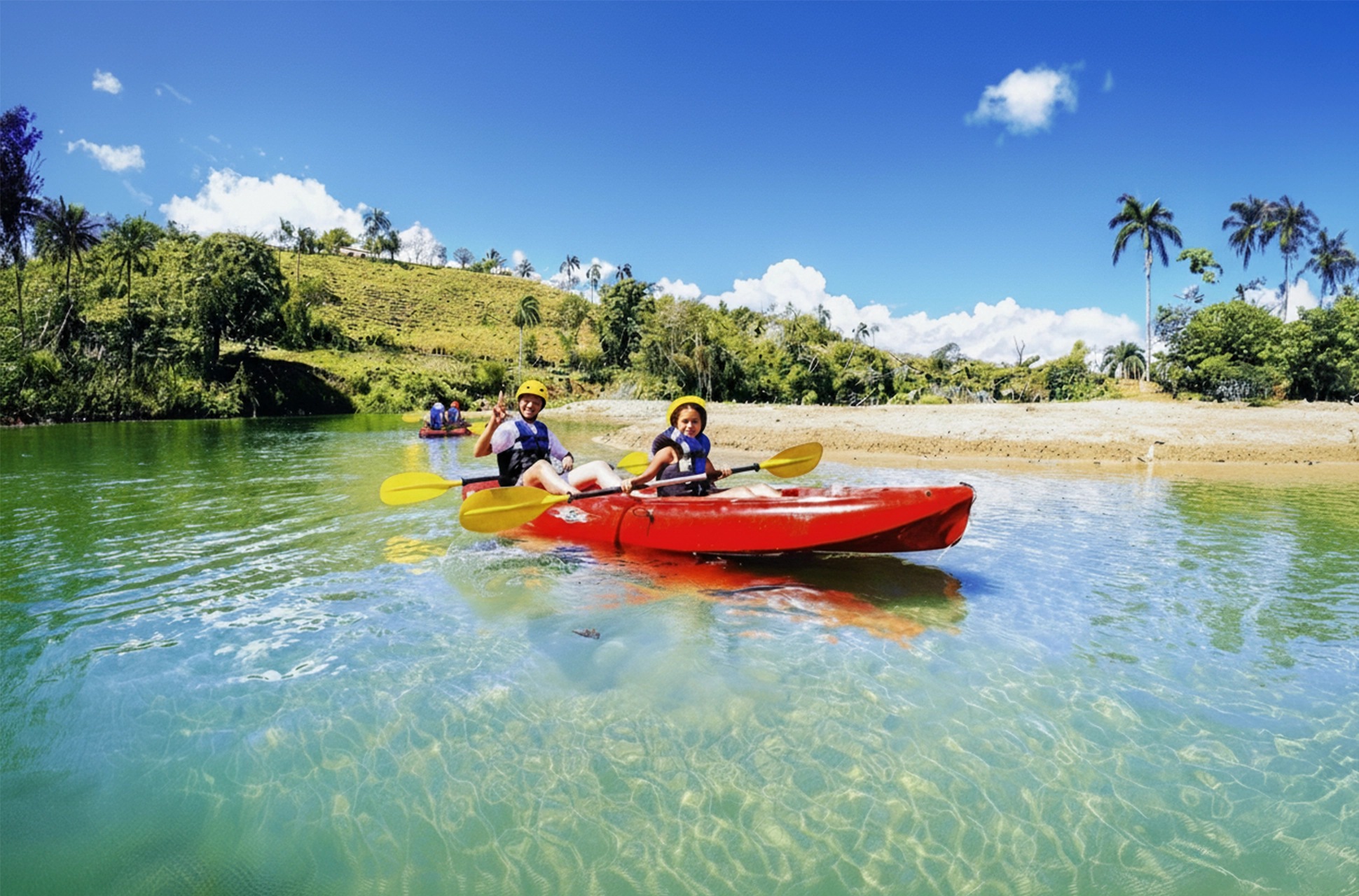 Family enjoying a kayak ride on Jamao River with clear turquoise water and palm trees in the background.