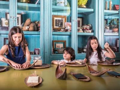 Family with children making chocolate at KahKow Experience in the Colonial Zone of Santo Domingo Dominican Republic