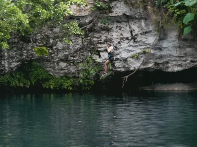 Traveler jumping into the turquoise waters of Laguna Dudú