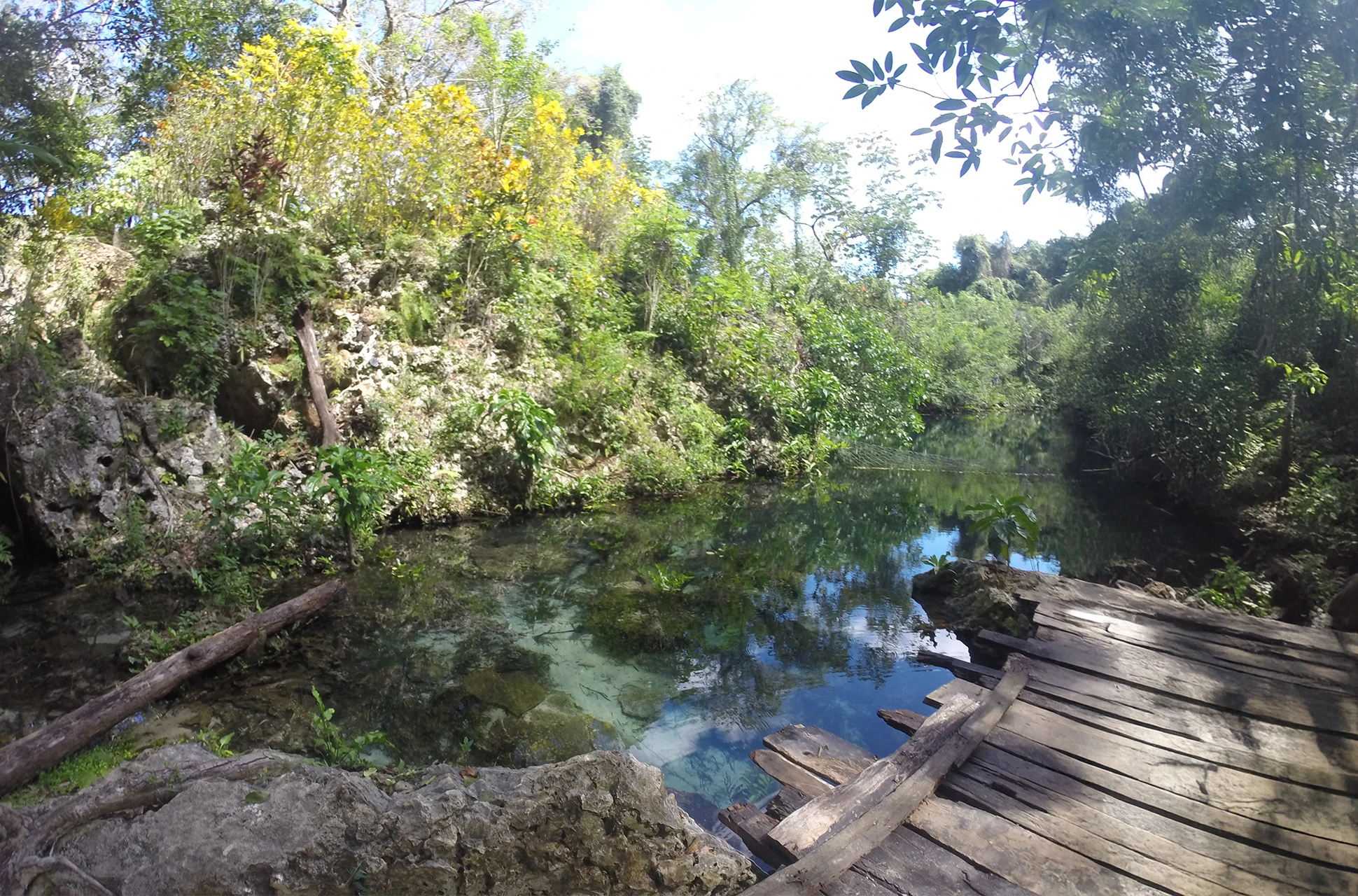 Wooden deck over clear waters at Laguna Dudú