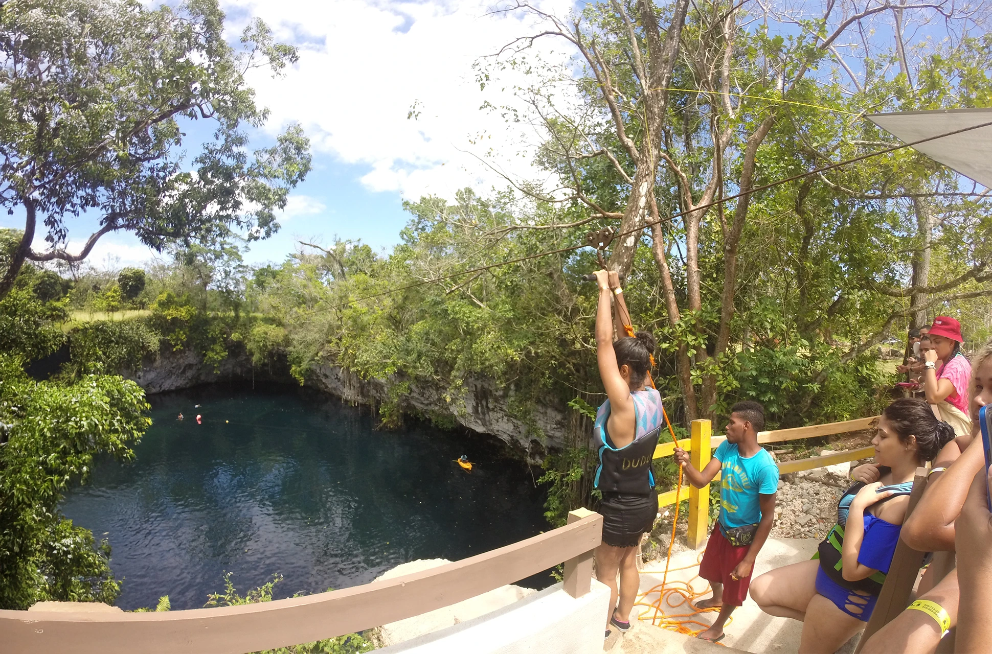 Traveler preparing to zipline into Laguna Dudú cenote