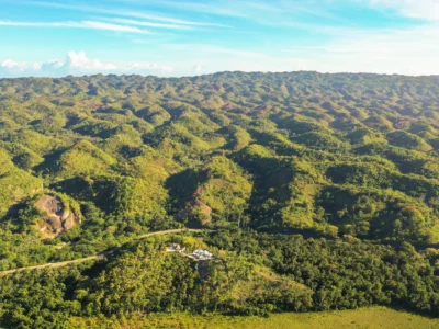 Drone view of rolling green hills and limestone formations in Los Haitises National Park
