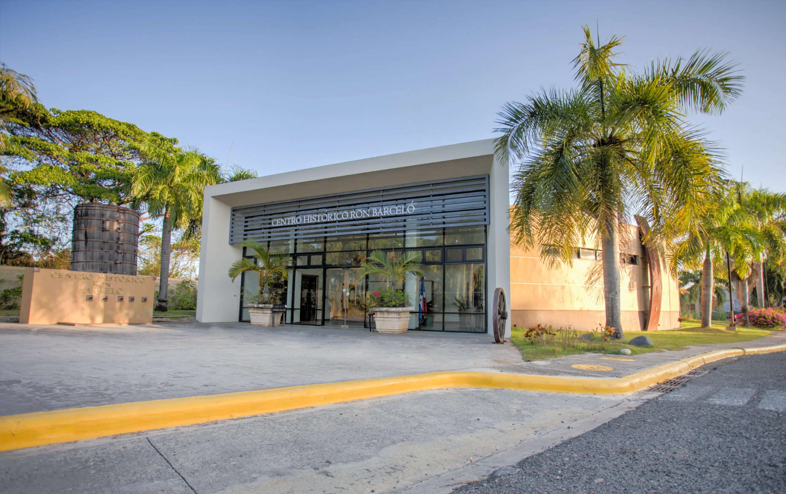 Main entrance of Ron Barceló Historic Center with palm trees.