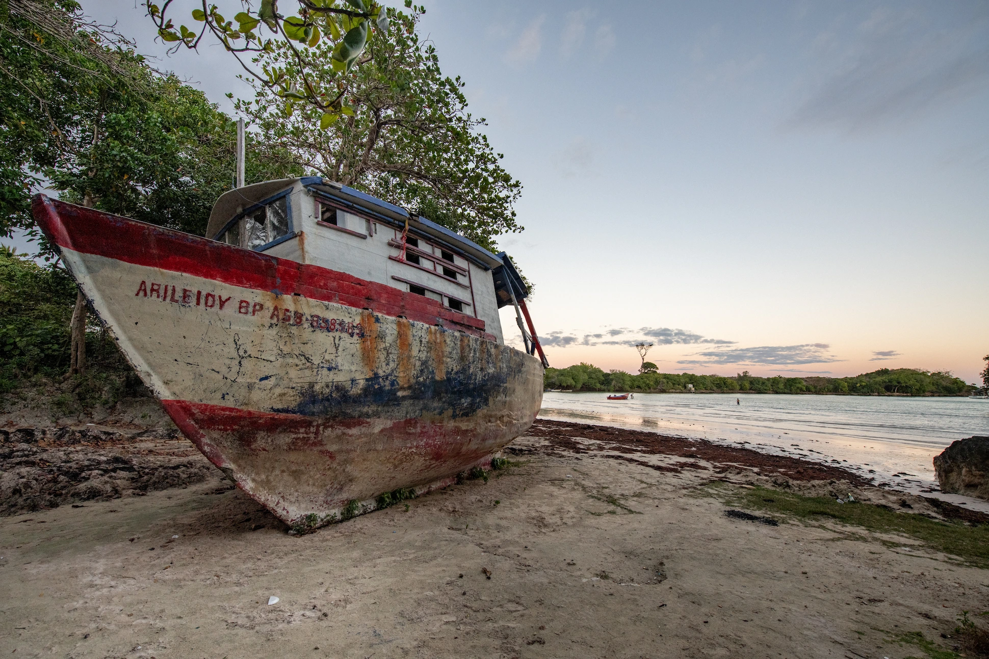 Old fishing boat on Playa Diamante beach at sunset