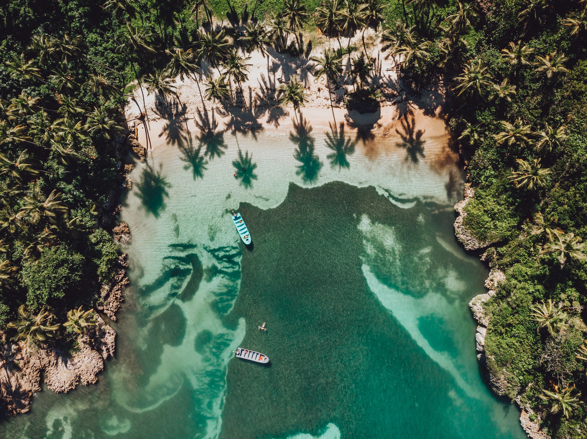 Aerial drone view of Playa Madama, a secluded beach in Samaná with turquoise waters and lush jungle.