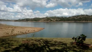 Aerial view of Taveras Dam in La Vega, Dominican Republic, surrounded by green hills and natural landscapes