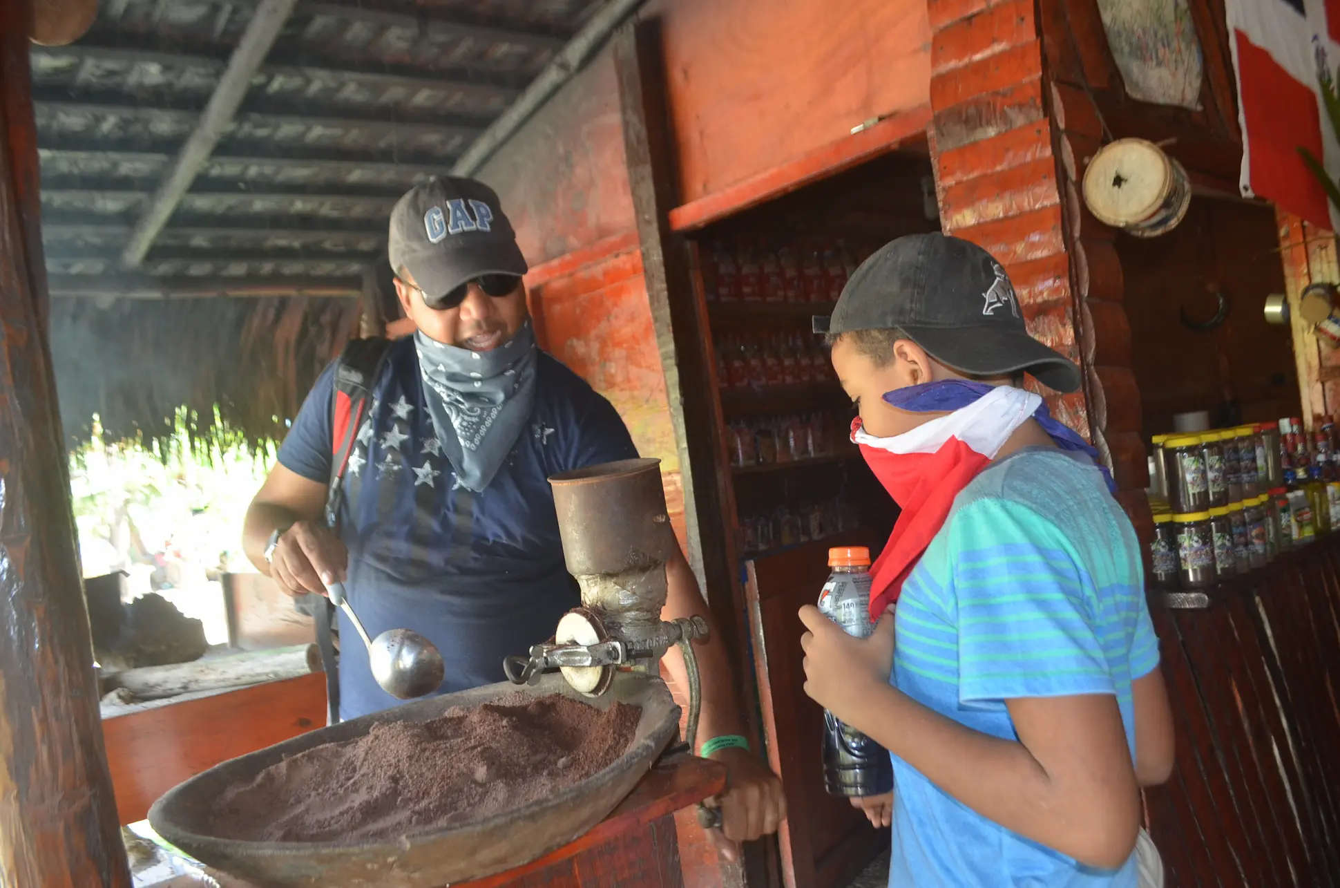 Father and son at a typical ranch in Punta Cana learning about coffee during the buggy tour from Santo Domingo