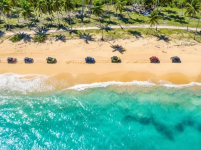 ATV buggies driving along Macao Beach in Punta Cana during an adventure tour from Santo Domingo