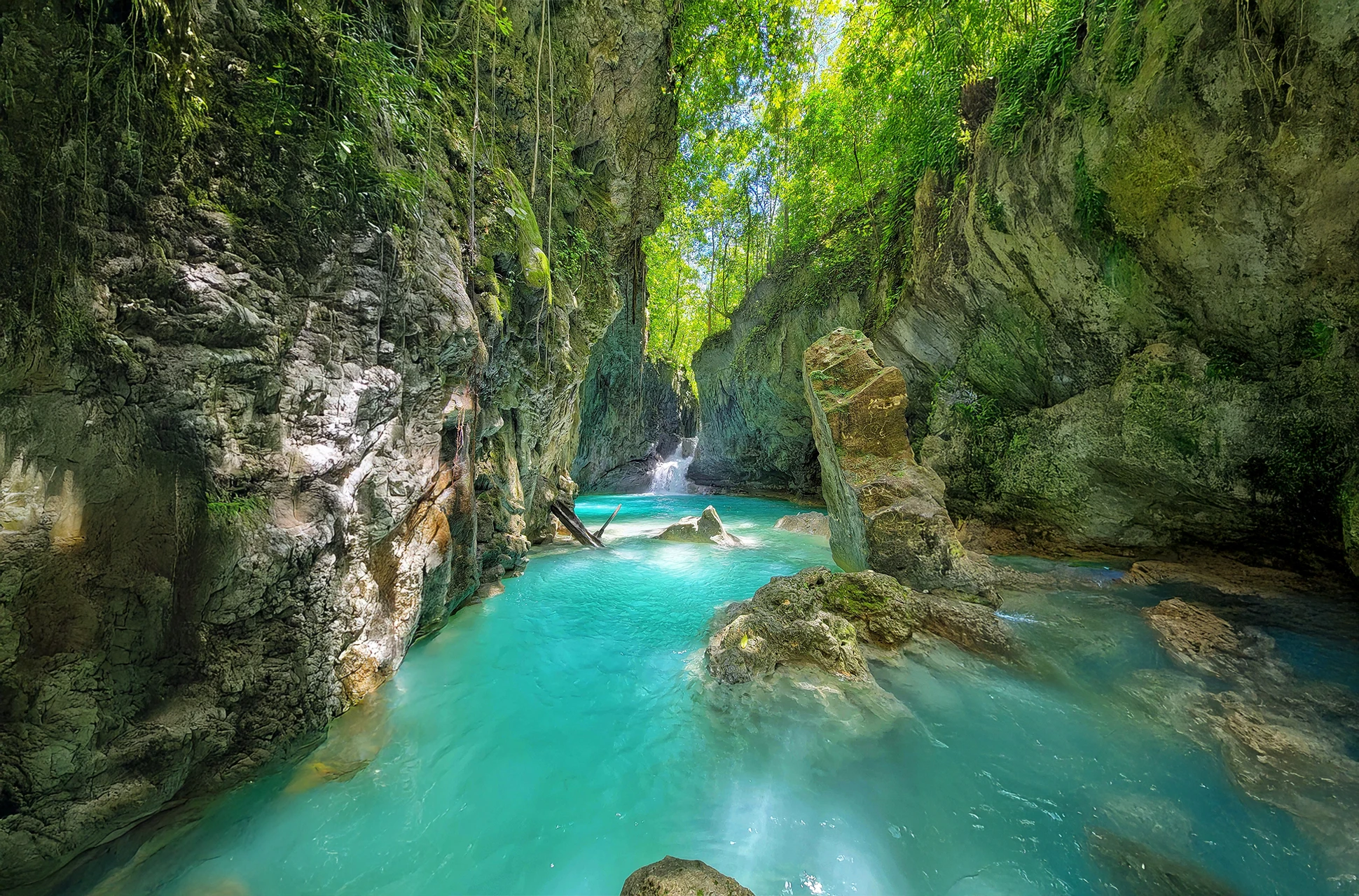 Turquoise natural pool at Río Partido surrounded by lush green jungle in the Dominican Republic