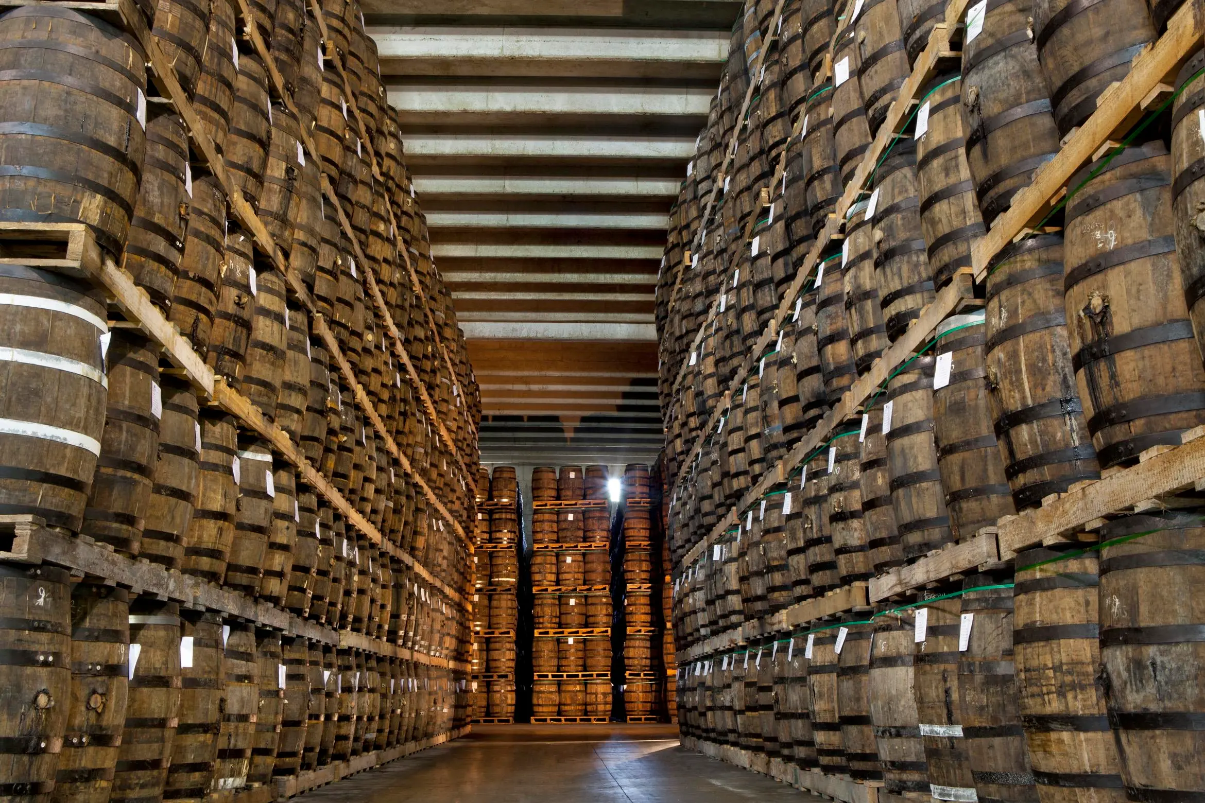 Rum barrels stacked inside the cellar at Ron Barceló factory.