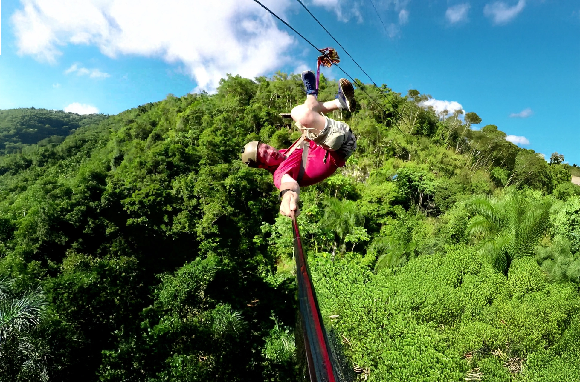 Adventurer capturing a selfie while gliding on the Samaná Zipline in the Dominican Republic.