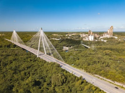 Aerial view of Puente Mauricio Báez in San Pedro de Macorís, Dominican Republic, with industrial zone in the background